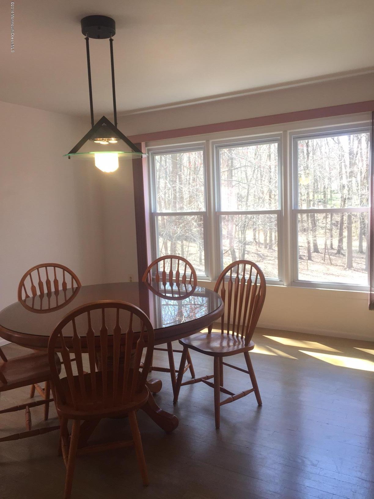 5 Knob Hill Road Morganville, NJ 07751 - Photo 4 of 6 a view of a dining room with furniture window and wooden floor