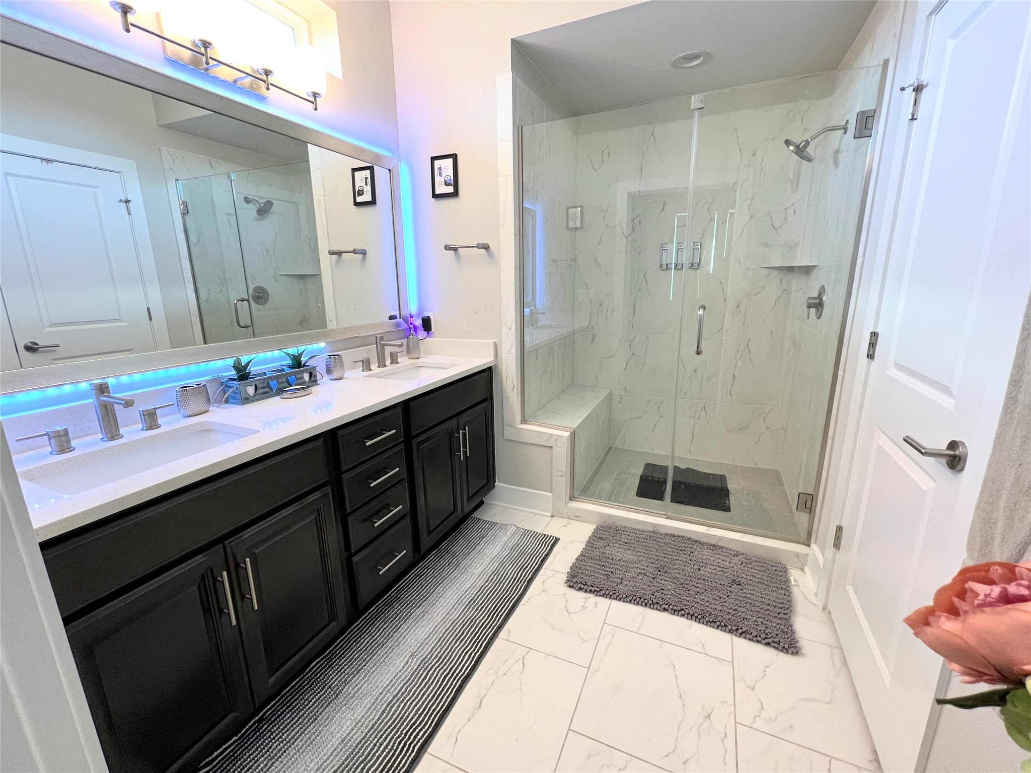 807 East 16th Street, Unit B Austin, TX 78702 - Photo 17 of 25 The primary bathroom features a modern design with dual vanities and a glass-enclosed shower for a spa-like experience.