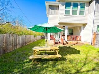 807 East 16th Street, Unit B Austin, TX 78702 - Photo 27 of 31 a view of a backyard with table and chairs under an umbrella