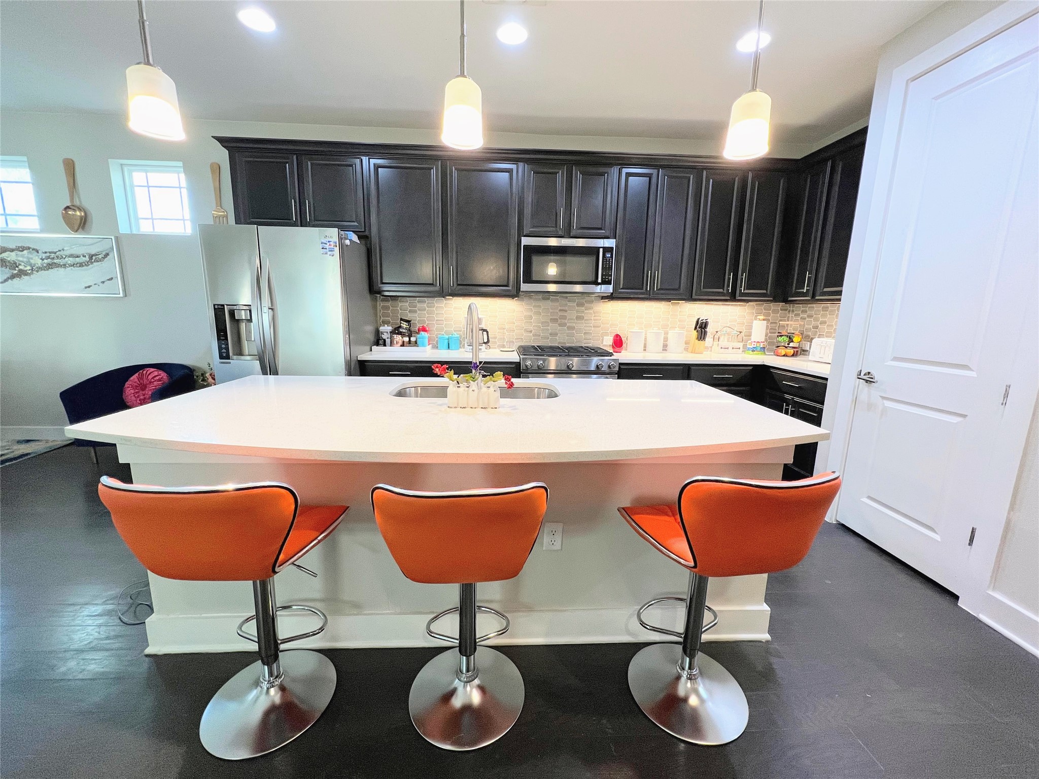 807 East 16th Street, Unit B Austin, TX 78702 - Photo 5 of 25 a kitchen with stainless steel appliances granite countertop a sink a stove a kitchen island a dining table and chairs