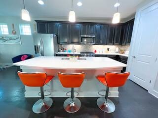 807 East 16th Street, Unit B Austin, TX 78702 - Photo 6 of 31 a kitchen with stainless steel appliances kitchen island granite countertop a sink a refrigerator and a stove
