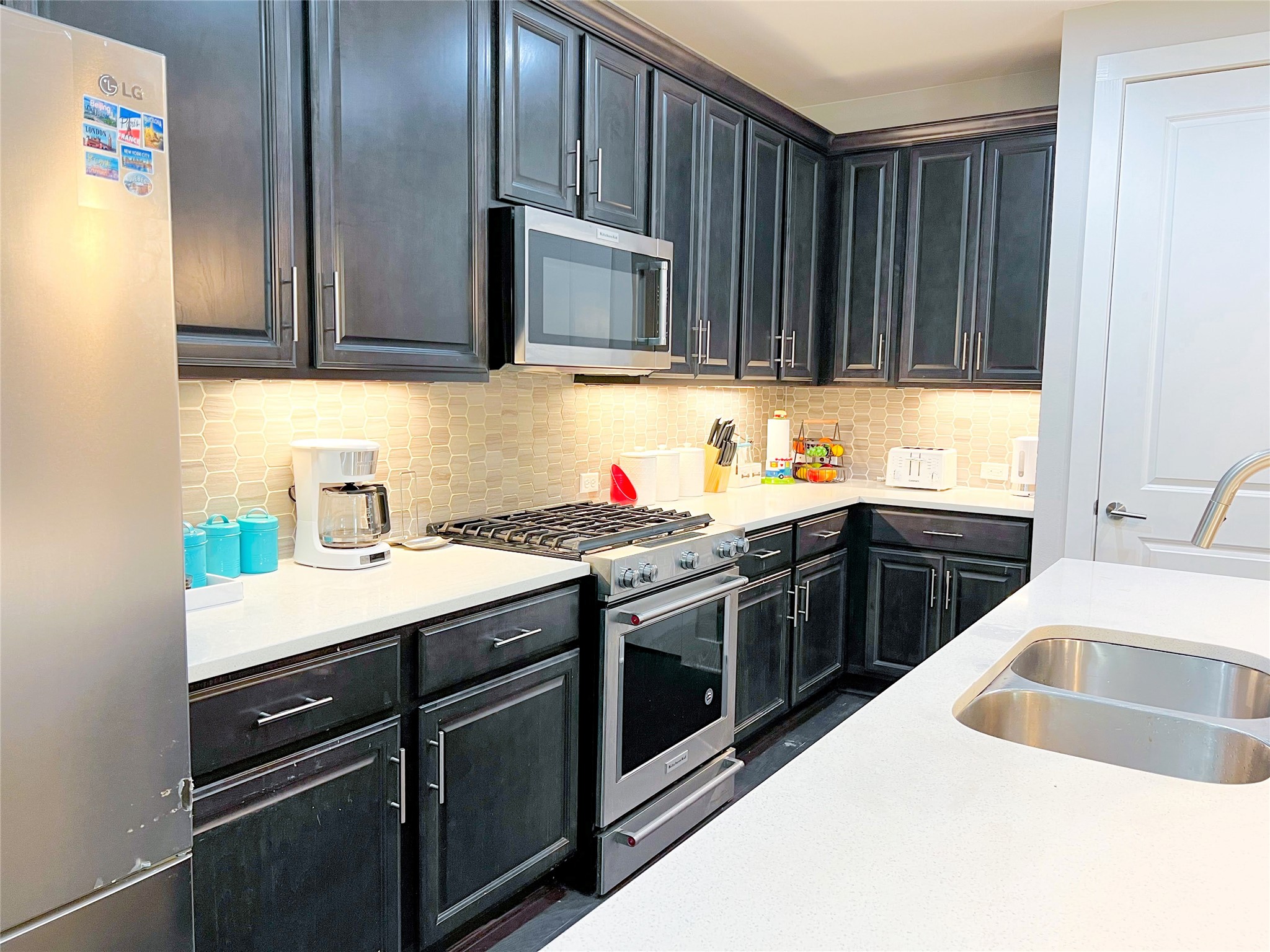 807 East 16th Street, Unit B Austin, TX 78702 - Photo 6 of 25 a kitchen with stainless steel appliances granite countertop a sink stove and cabinets