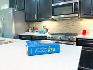 807 East 16th Street, Unit B Austin, TX 78702 - Photo 7 of 31 a kitchen with stainless steel appliances a stove a microwave and refrigerator