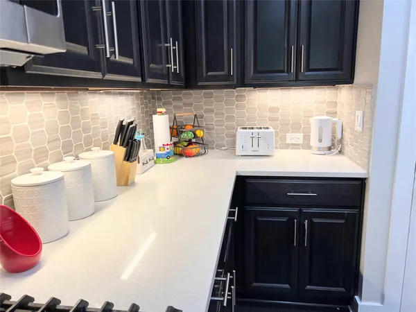 a kitchen with a sink cabinets and appliances
