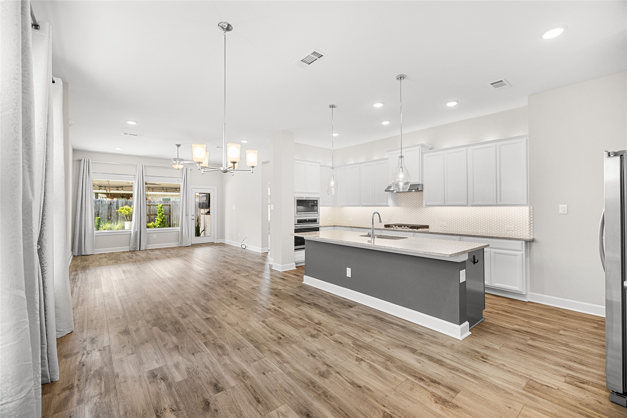 15611 Rising Wren Court Conroe, TX 77302 - Photo 7 of 41 Dining Area looking into Kitchen and Living/Den Area