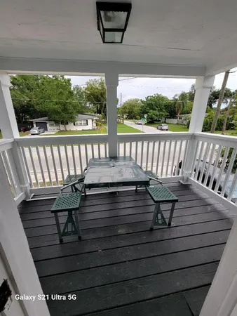 a view of balcony with wooden floor