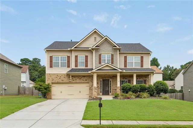a front view of a house with a yard