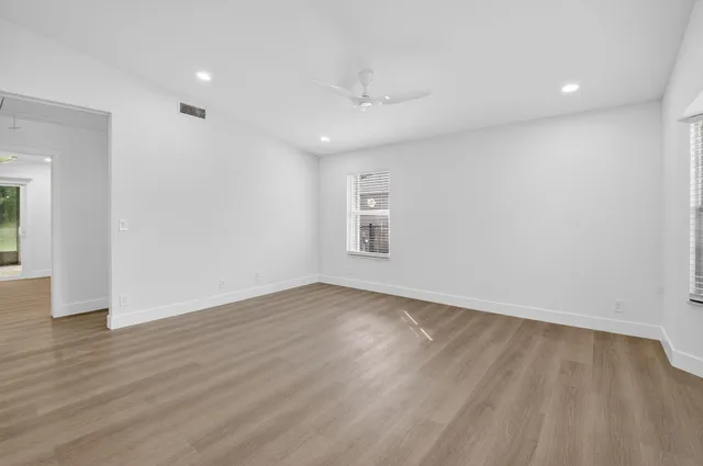 an empty room with windows and closet