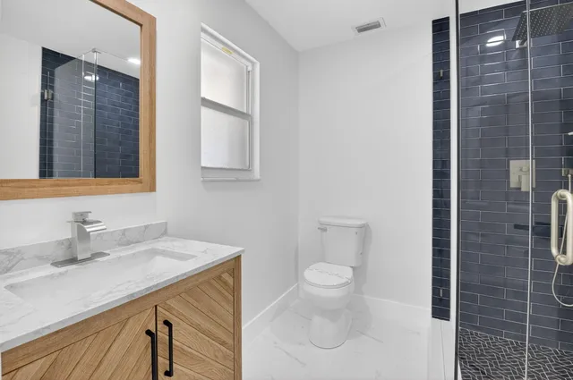 a bathroom with a toilet and a shower