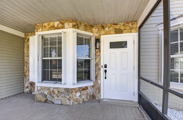 a view of a house with a door and wooden walls