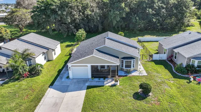 an aerial view of residential houses with outdoor space and swimming pool