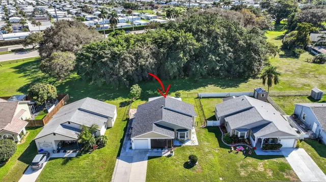 an aerial view of residential house with outdoor space and swimming pool