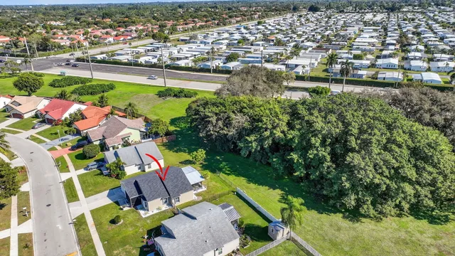 an aerial view of a houses with a swimming pool