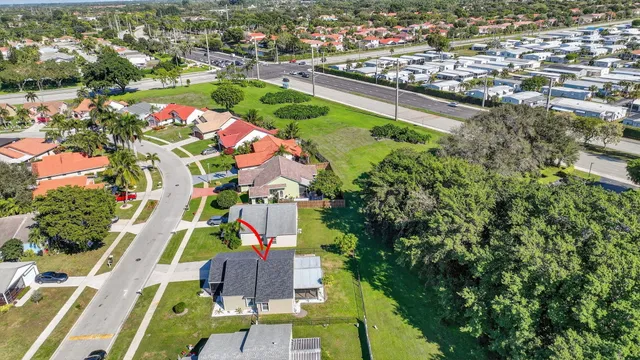 aerial view of a house with a yard