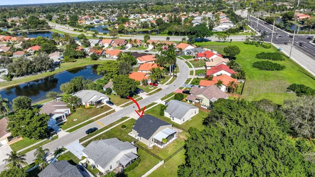 an aerial view of a houses with swimming pool