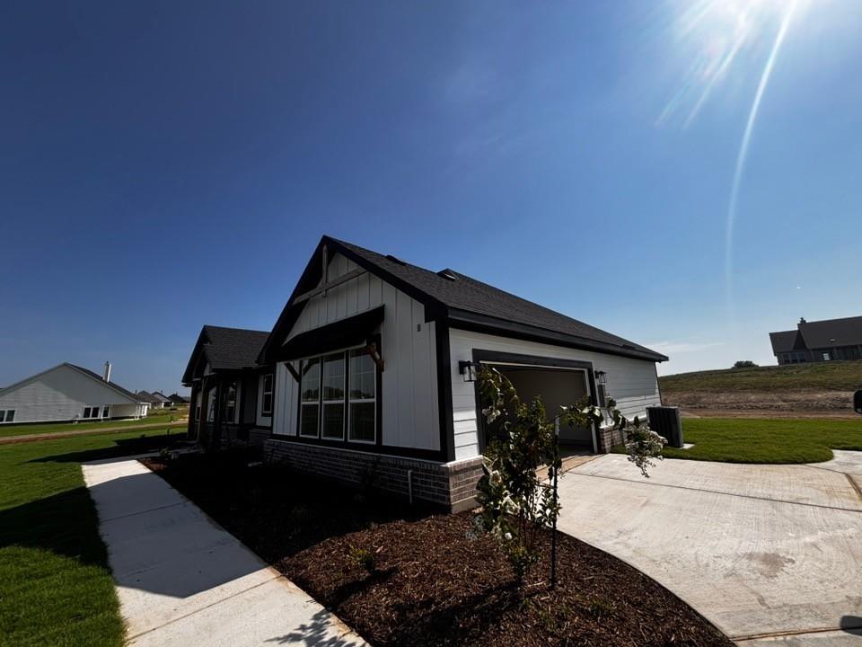 149 Big Sky Road Decatur, TX 76234 - Photo 1 of 11 White siding exterior with dark trim accents