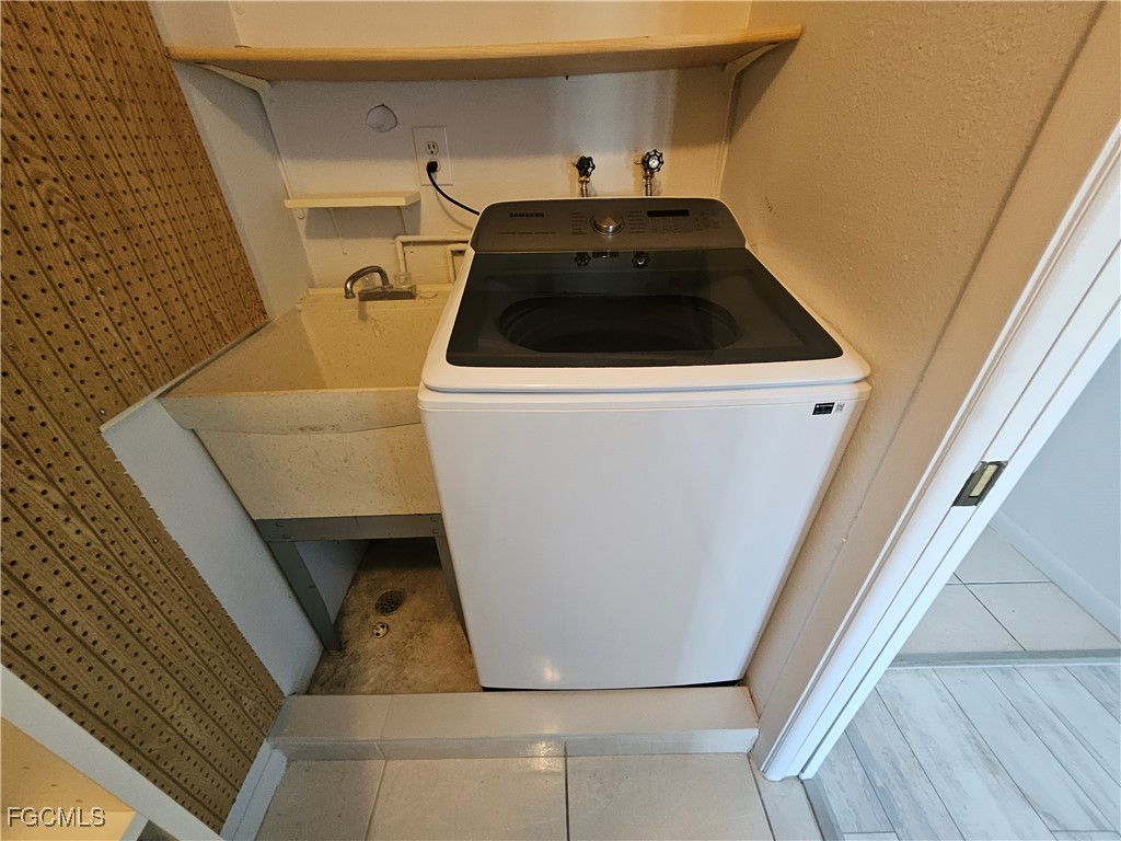 1830 Brantley Road, Unit F204 Fort Myers, FL 33907 - Photo 12 of 23 a kitchen with a sink and washing machine