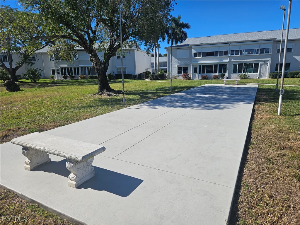 1830 Brantley Road, Unit F204 Fort Myers, FL 33907 - Photo 16 of 23 a front view of a house with garden
