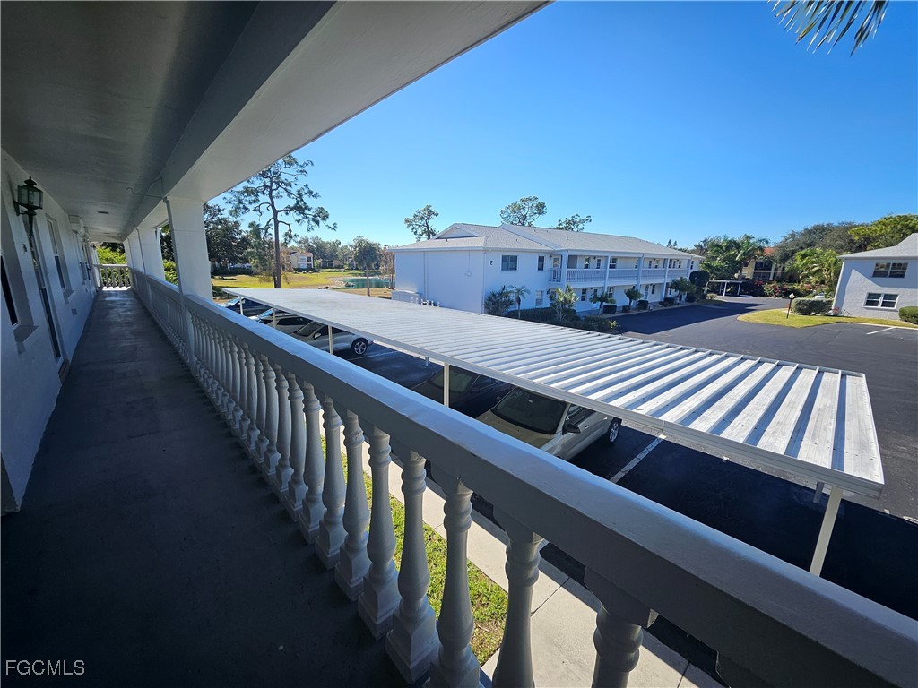 1830 Brantley Road, Unit F204 Fort Myers, FL 33907 - Photo 20 of 23 a view of balcony with wooden floor
