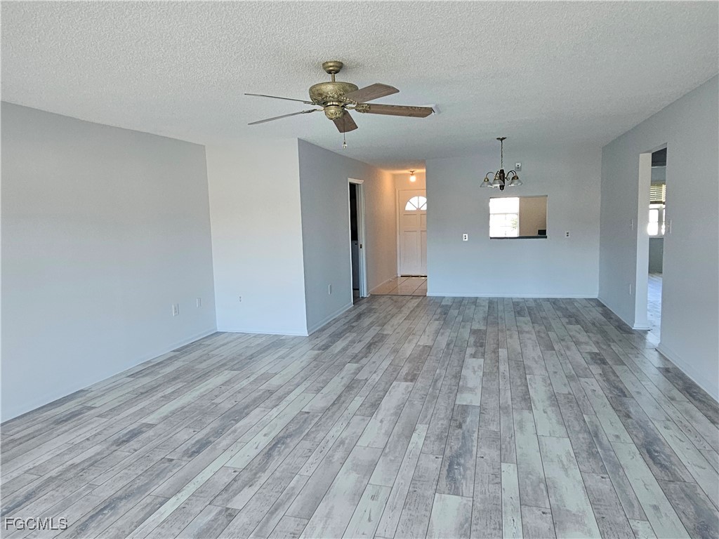 1830 Brantley Road, Unit F204 Fort Myers, FL 33907 - Photo 21 of 23 wooden floor in an empty room with a window