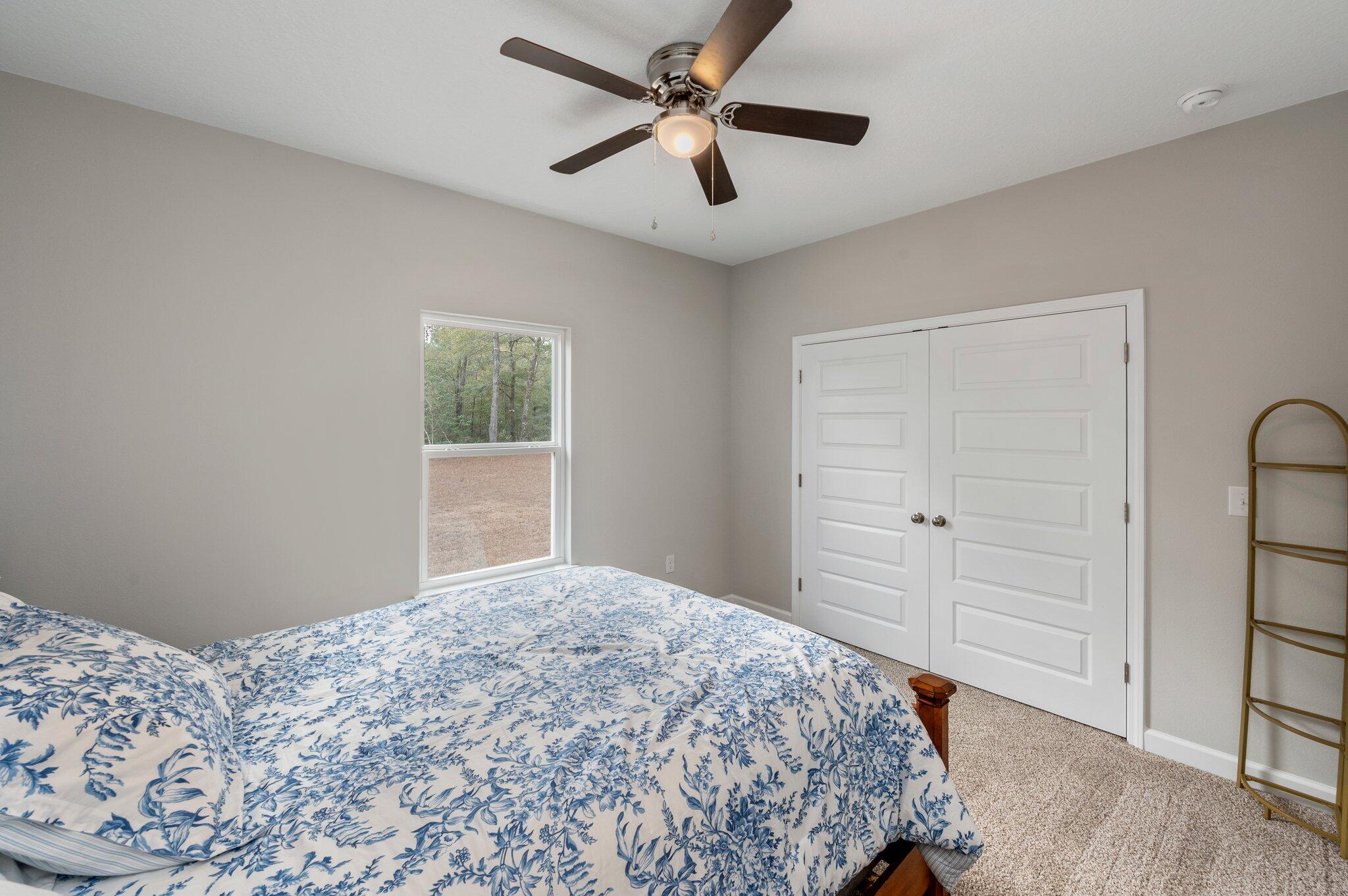 5754 Wayne Rogers Road Crestview, FL 32539 - Photo 18 of 44 a bedroom with a bed and a window