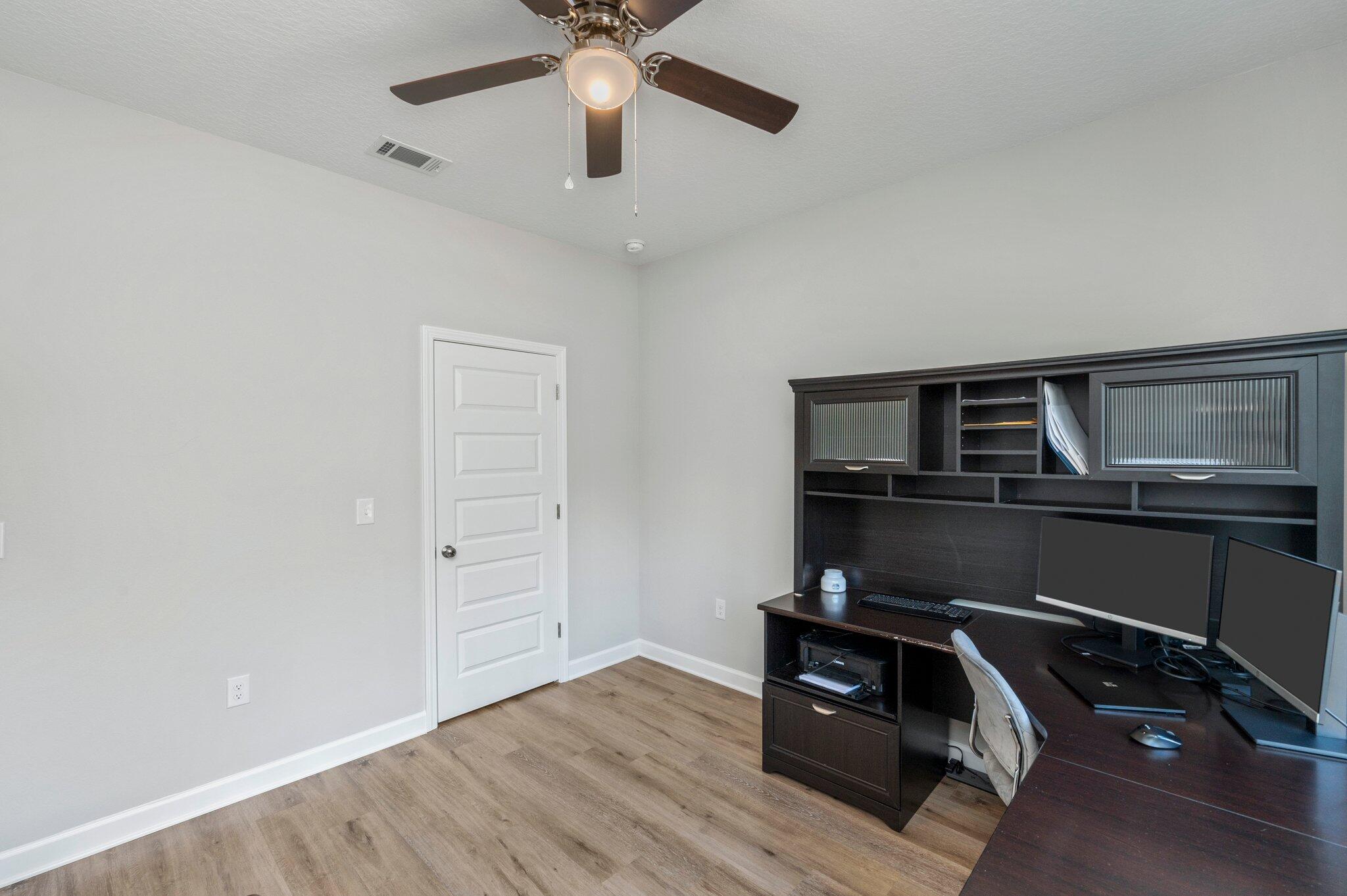 5754 Wayne Rogers Road Crestview, FL 32539 - Photo 23 of 44 a view of an empty room with wooden floor