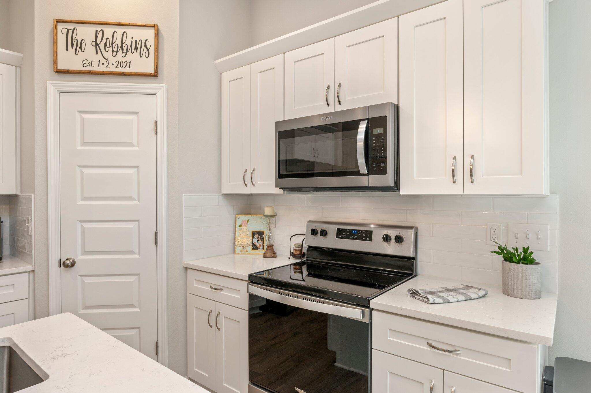 5754 Wayne Rogers Road Crestview, FL 32539 - Photo 5 of 44 a kitchen with white cabinets stainless steel appliances and sink
