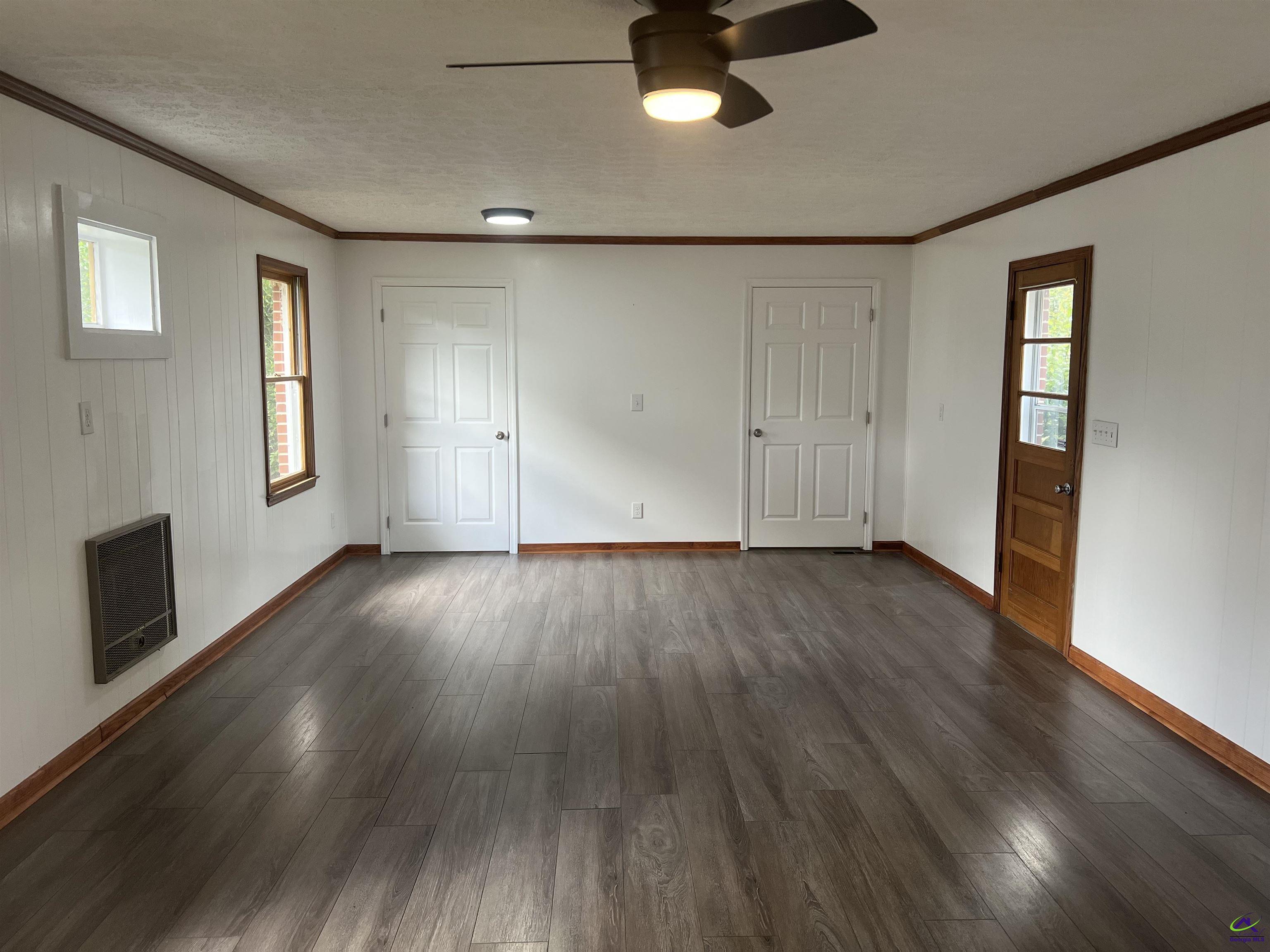 145 South 2nd Street Cochran, GA 31014 - Photo 17 of 24 an empty room with wooden floor and windows