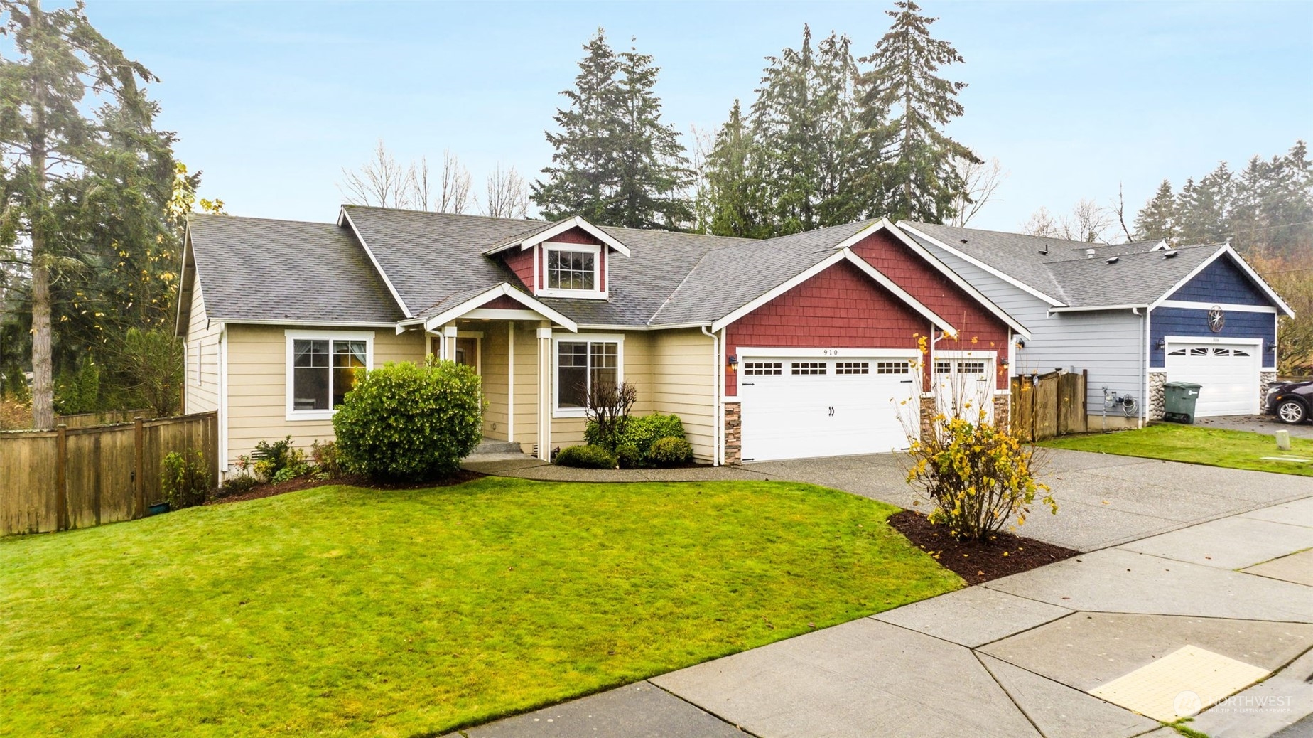 a front view of a house with yard and green space