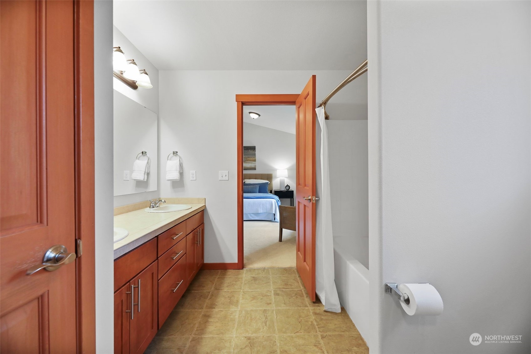 910 209th Street Southeast Bothell, WA 98021 - Photo 18 of 28 a bathroom with a granite countertop sink a mirror and a bathtub