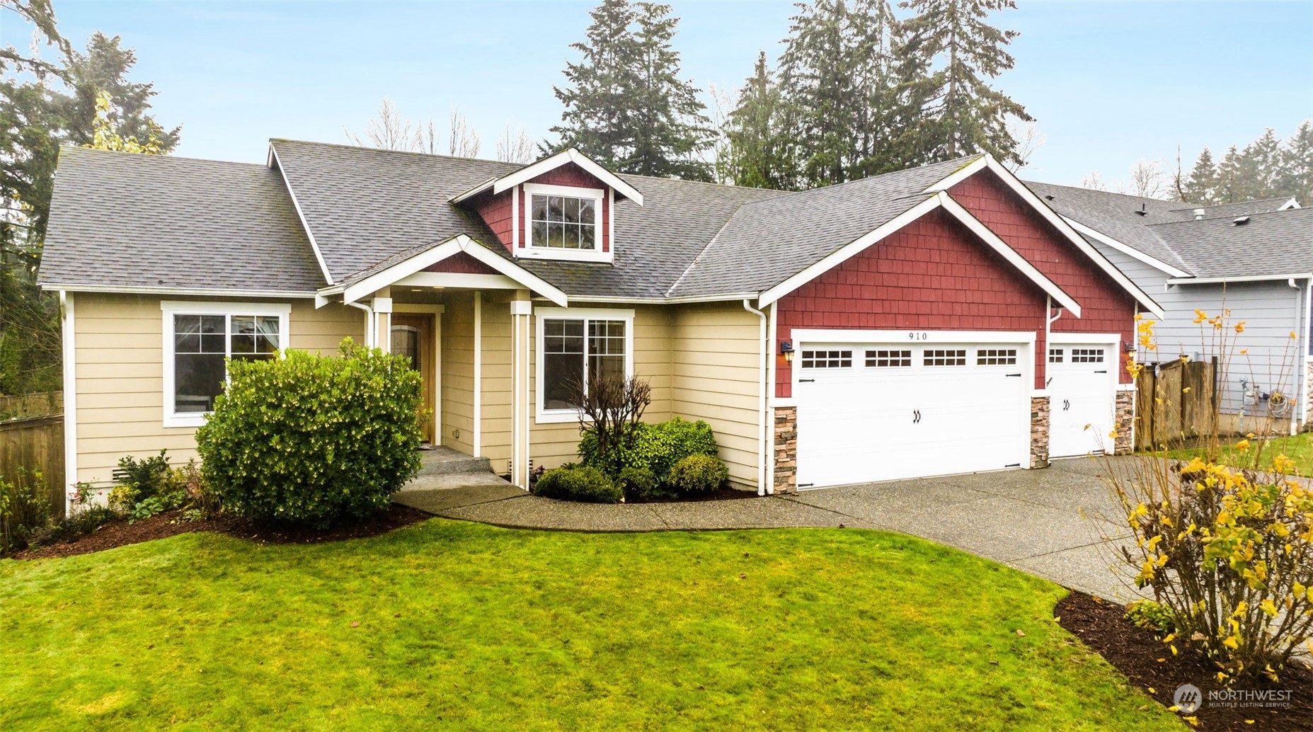 910 209th Street Southeast Bothell, WA 98021 - Photo 2 of 28 a front view of a house with a garden