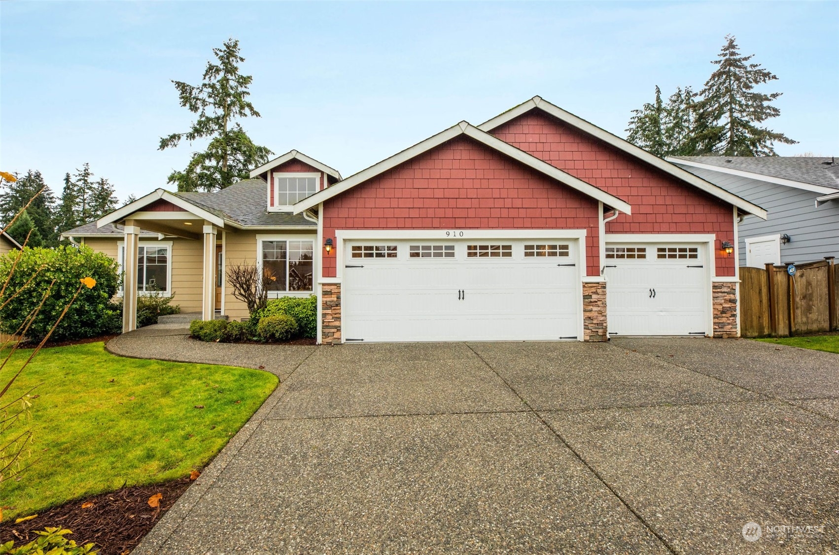 910 209th Street Southeast Bothell, WA 98021 - Photo 4 of 28 a front view of a house with a yard and garage