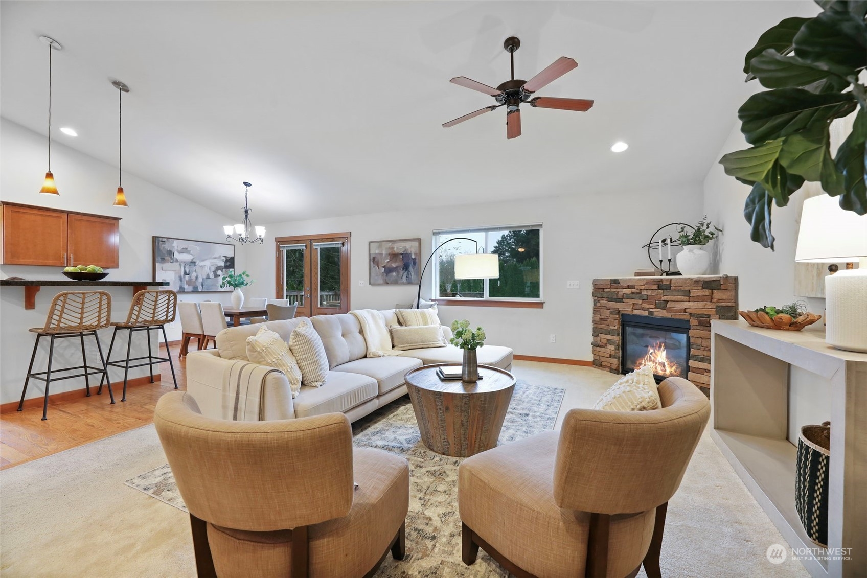 910 209th Street Southeast Bothell, WA 98021 - Photo 9 of 28 a living room with furniture a fireplace and a chandelier