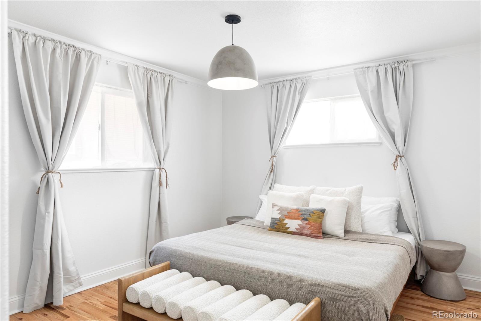 2313 South Race Street, Unit A Denver, CO 80210 - Photo 11 of 16 a bedroom with a bed and a window