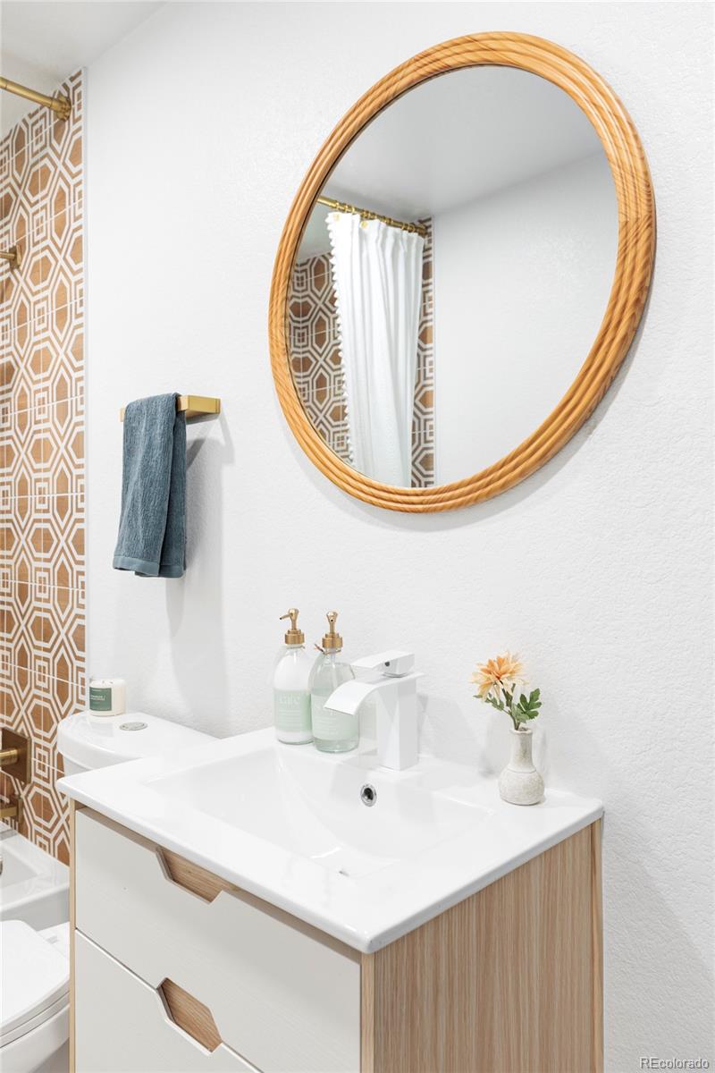 2313 South Race Street, Unit A Denver, CO 80210 - Photo 14 of 16 a bathroom with a sink and a mirror