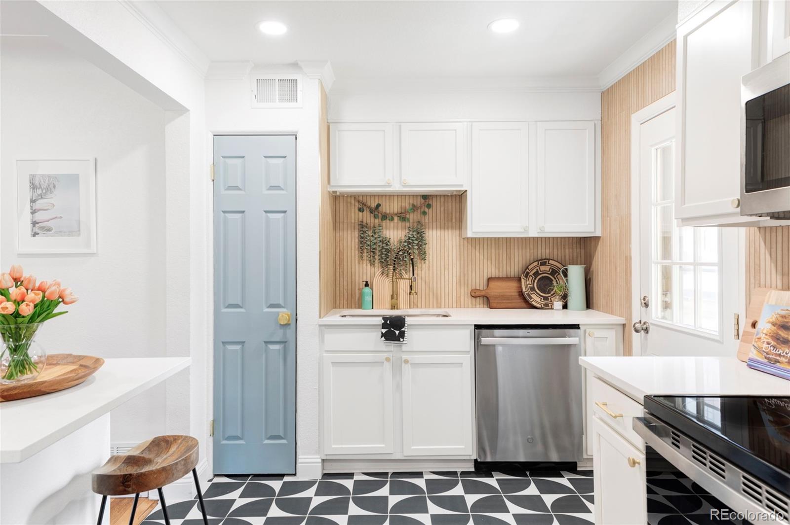 2313 South Race Street, Unit A Denver, CO 80210 - Photo 2 of 16 a kitchen with stainless steel appliances a stove a sink and a refrigerator