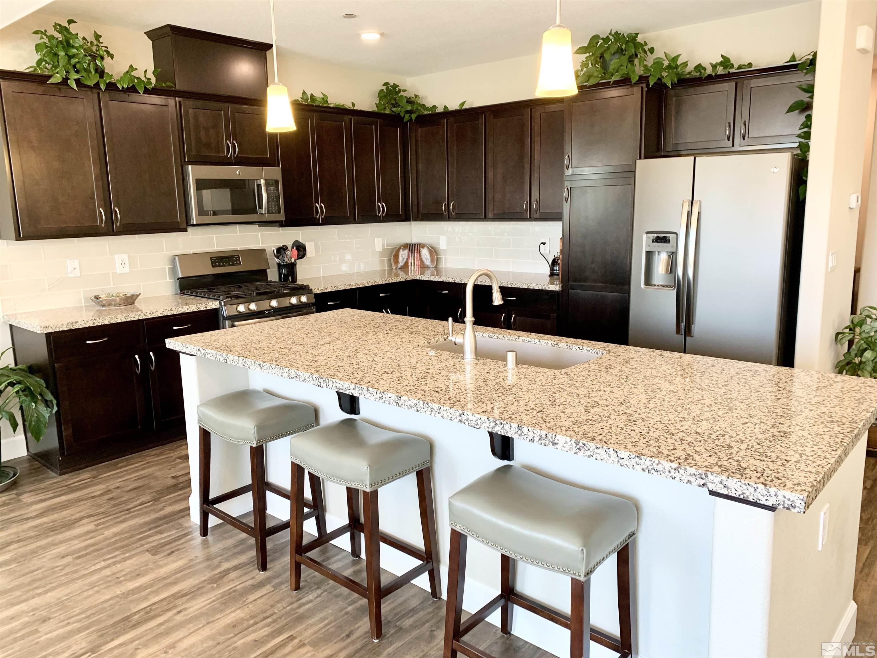 1970 Dark Horse Road, Unit C Reno, NV 89521 - Photo 13 of 35 a kitchen with stainless steel appliances granite countertop a sink refrigerator and microwave