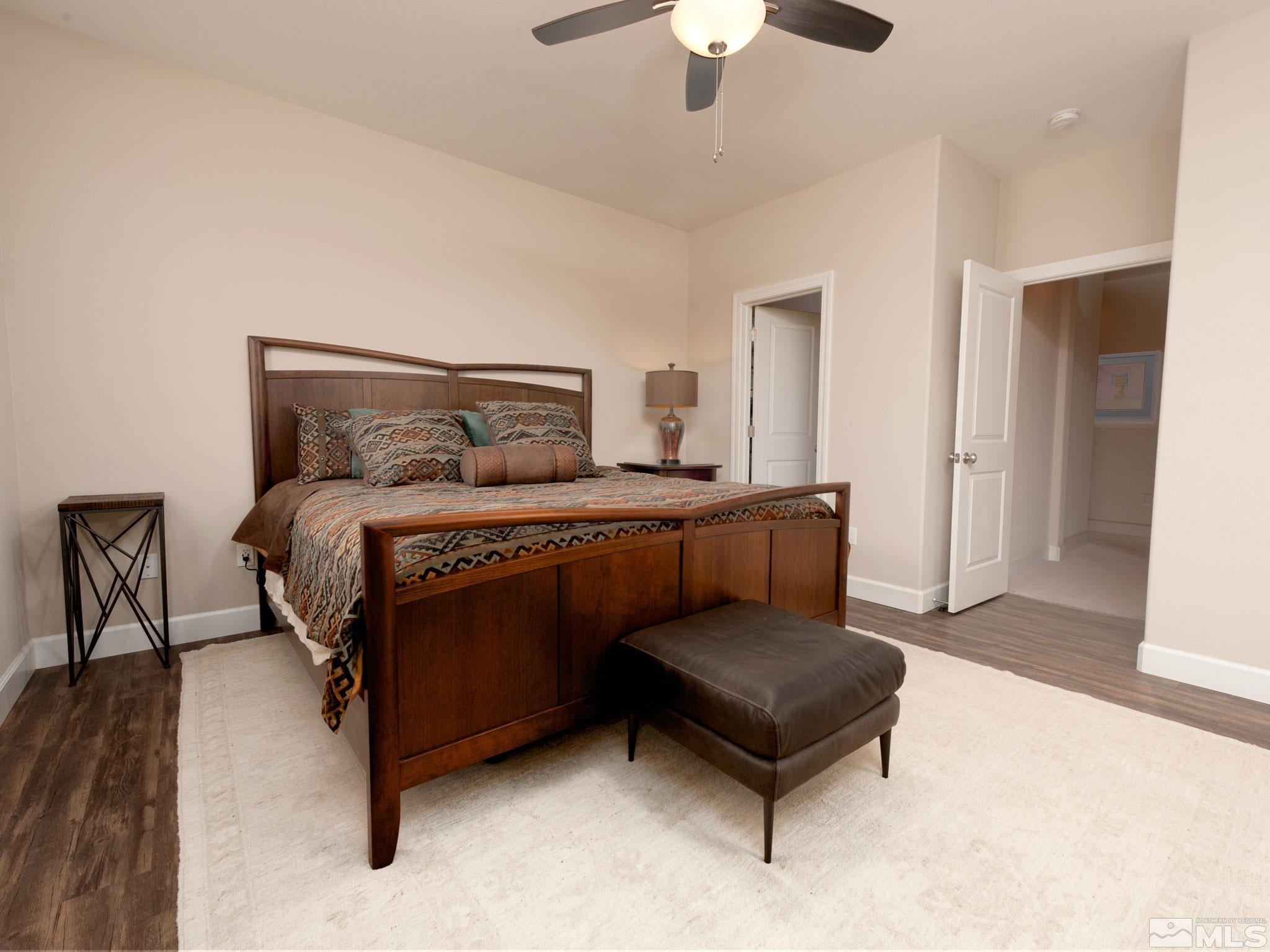 1970 Dark Horse Road, Unit C Reno, NV 89521 - Photo 19 of 35 a bedroom with a bed and a chandelier