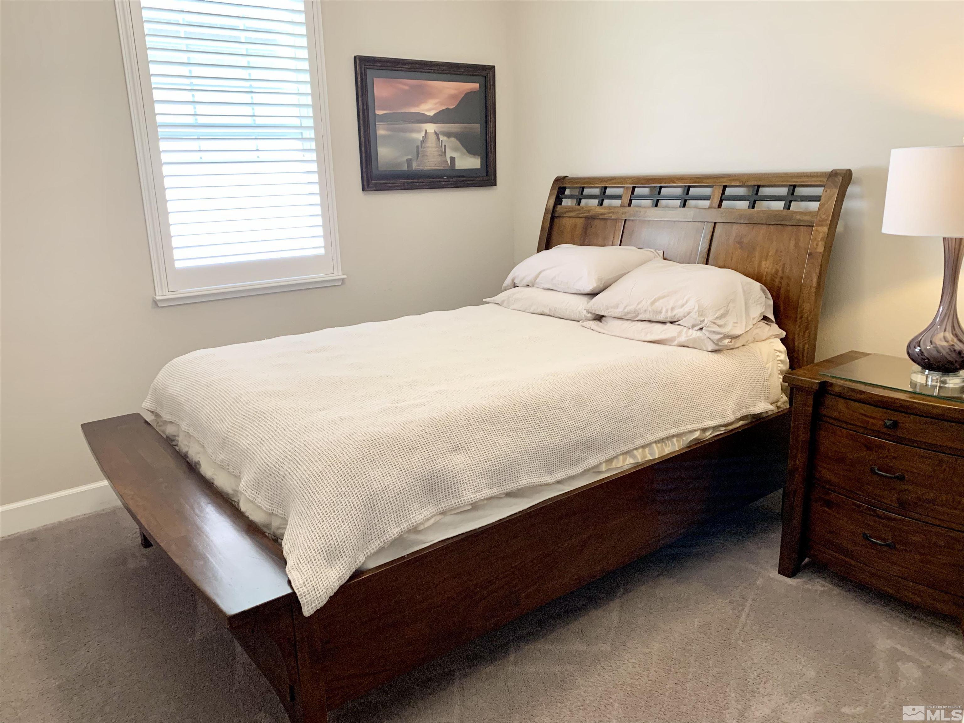 1970 Dark Horse Road, Unit C Reno, NV 89521 - Photo 22 of 35 a large bed sitting in a bedroom next to a window