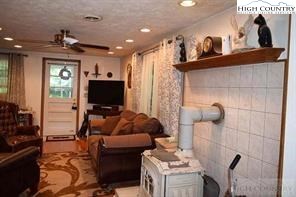 1495 Cobbs Creek Road Boone, NC 28607 - Photo 15 of 22 a living room with furniture and a flat screen tv