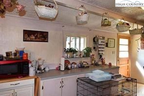 1495 Cobbs Creek Road Boone, NC 28607 - Photo 18 of 22 a kitchen with a refrigerator and a stove