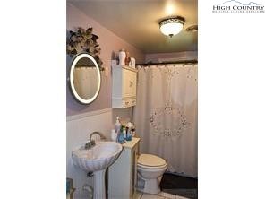 1495 Cobbs Creek Road Boone, NC 28607 - Photo 5 of 22 a bathroom with a toilet sink vanity tub and mirror
