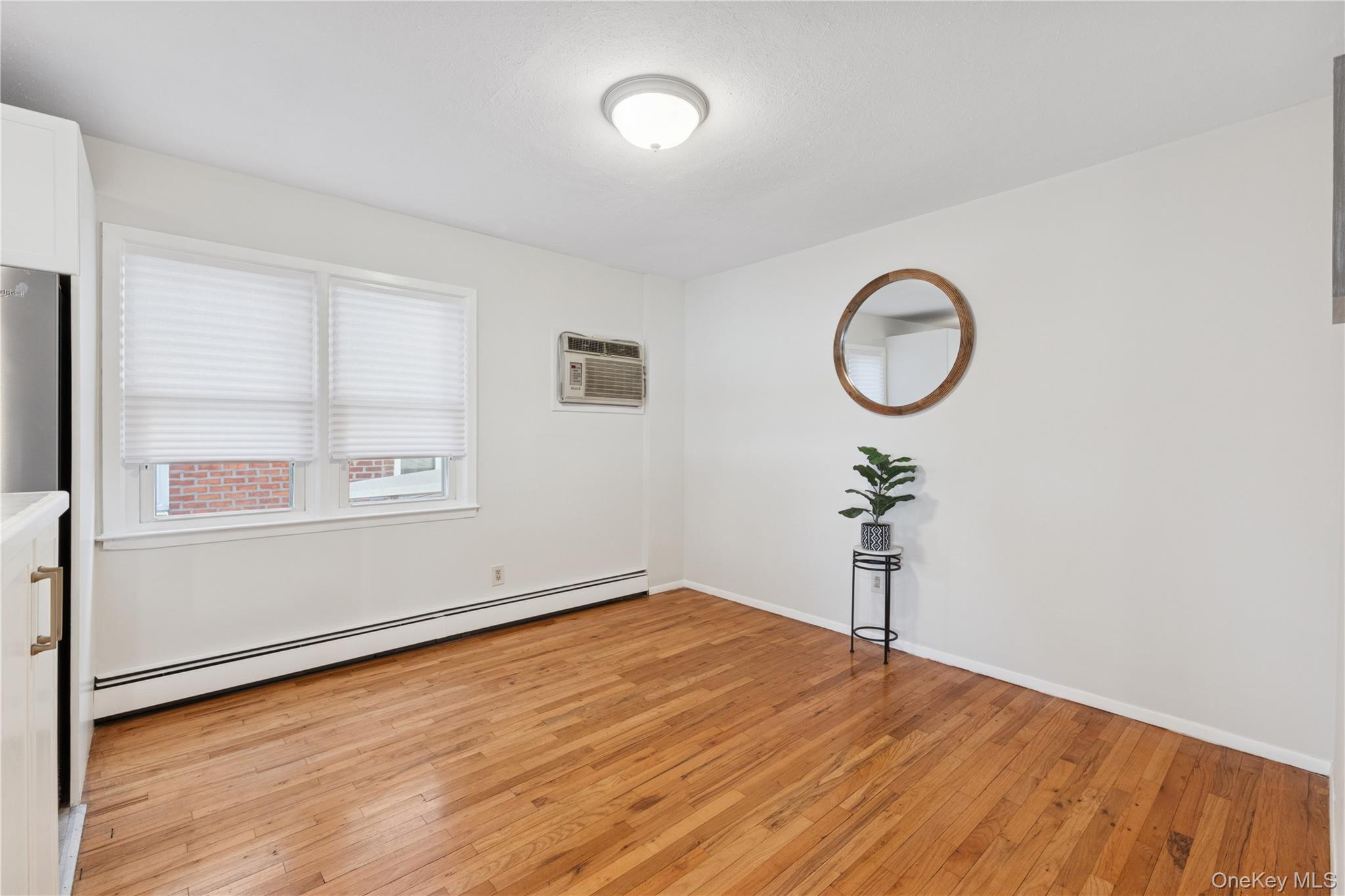 154-27 20th Road Queens, NY 11357 - Photo 11 of 30 a view of a room with wooden floor and white walls