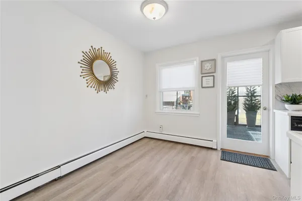 a view of room with window and wooden floor