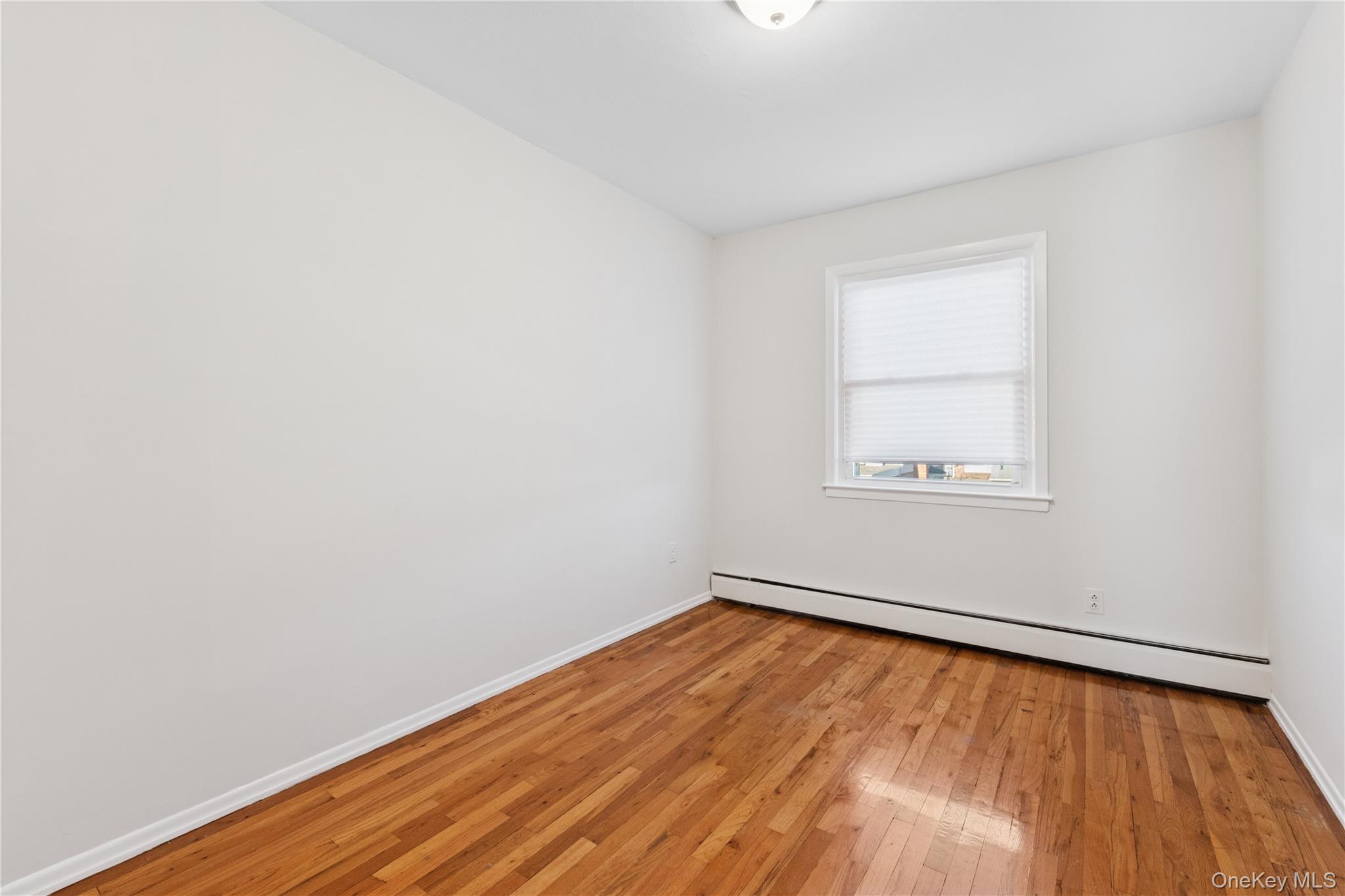 154-27 20th Road Queens, NY 11357 - Photo 17 of 30 an empty room with a window