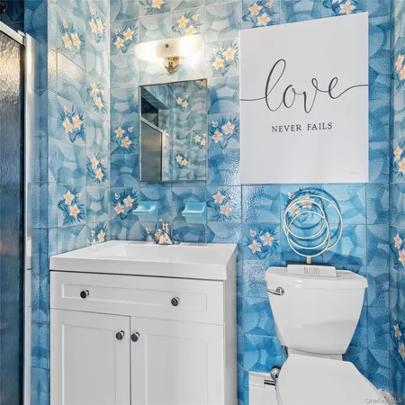 a bathroom with a toilet sink and mirror