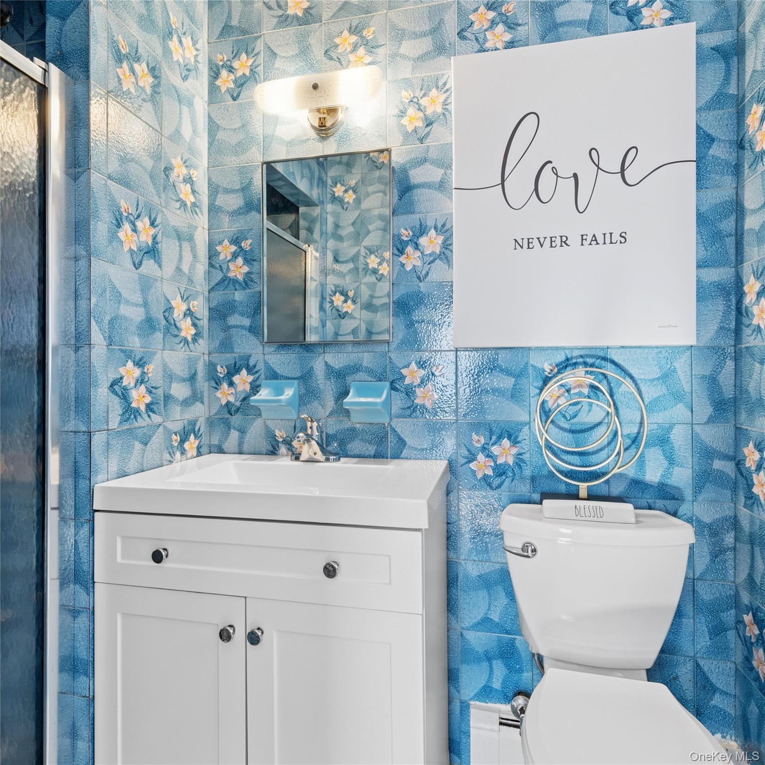 154-27 20th Road Queens, NY 11357 - Photo 18 of 30 a bathroom with a toilet sink and mirror