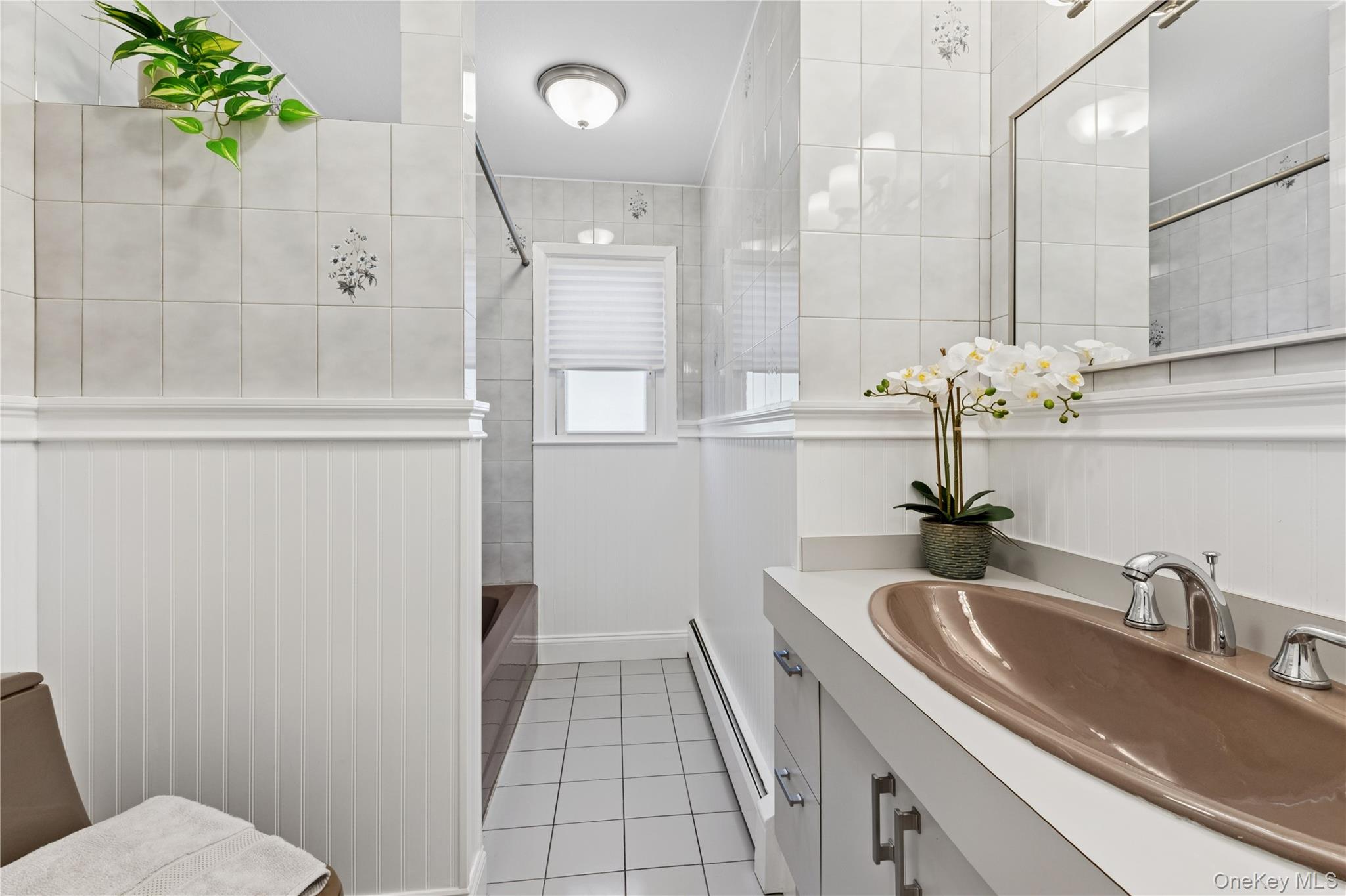 154-27 20th Road Queens, NY 11357 - Photo 19 of 30 a bathroom with a sink and mirror with bathtub