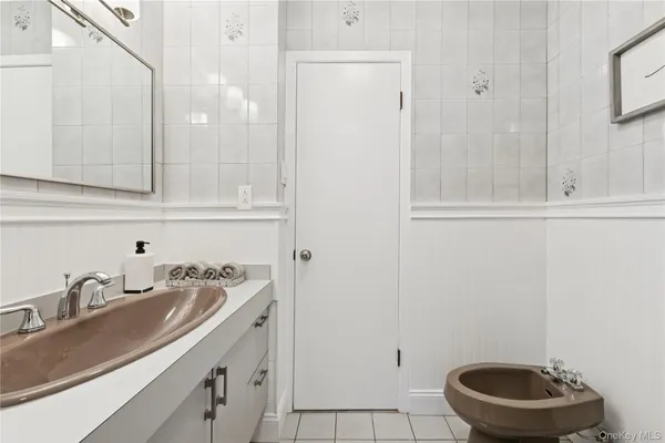 a bathroom with a sink a toilet and a mirror