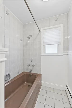 a bathroom with a tub and a shower